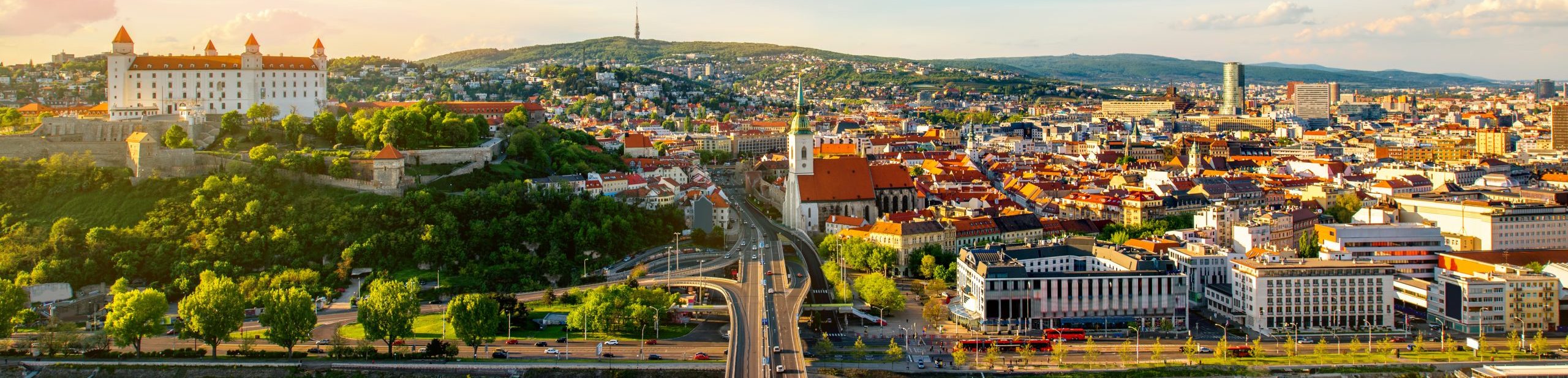 Bratislava aerial cityscape view on the old town with Saint Martin's cathedral, castle hill and Danube river on the sunset in Slovakia. Wide angle view with copy space
